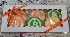 four cookies wrapped in cellophane and tied with orange ribbon