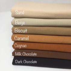 six different colored sheets stacked on top of each other with the words sand, biscuit, caramel, cocoa, milk chocolate and dark chocolate