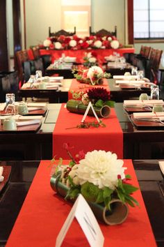 the tables are set with red and white linens