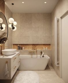 a white bath tub sitting next to a sink in a bathroom under a round mirror