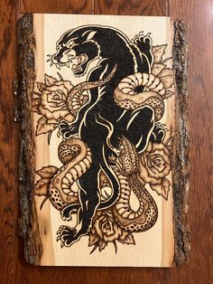 a wooden plaque with a dragon and roses on it