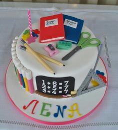 there is a cake with school supplies on it