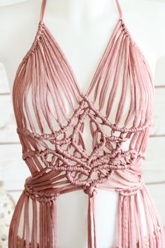 a pink halter top with tassels on it