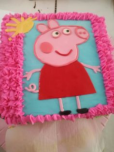 a peppa pig cake with pink icing on it's face and arms