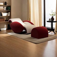 a living room filled with furniture next to a window covered in curtains and drapes