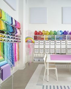 We loved transforming this workspace for our client! For the ribbon wall, we used a pegboard with peg hooks and paper towel holders, shelving from IKEA, storage bins from The Container Store and Amazon, and an adorable rainbow rug from Ruggable and The Home Edit. Click the link to see the INCREDIBLE before-and-after transformation.