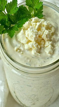 a glass jar filled with food and garnished with parsley