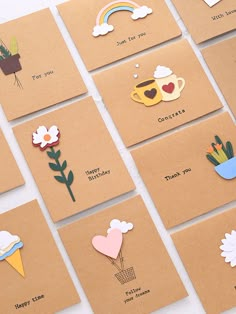 there are many different cards with flowers and hearts on them, one has a rainbow in the background