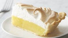 a slice of lemon meringue pie on a white plate