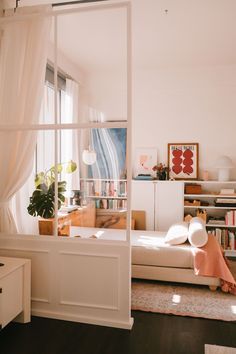 a living room filled with furniture and a window