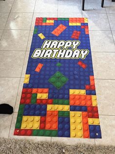 a birthday rug is on the floor in front of a chair