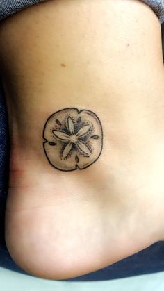 a small tattoo on the side of a woman's stomach that has a starfish in it