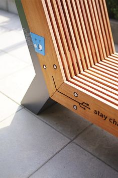 a wooden bench sitting on top of a sidewalk