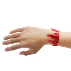 a woman's hand with red nail polish on it and a bracelet that has the word love written on it