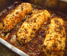 some chicken in a pan with sauce and seasoning on the side, ready to be cooked