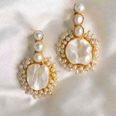 The Amelia dangle pearl earrings are the perfect statement to bring out your feminine, romantic side. Featuring 22ct gold-plated brass, freshwater baroque pearls, and acrylic pearls. Handmade by artisans in India. Limited quantity available. For pierced ears22ct gold plated brassCream baroque pearlsAcrylic pearls Size Dangle Pearl Earrings, Drop Pearl Earrings, Unique Wedding Jewelry, Vintage Statement Earrings, Pearl Statement Earrings, Pure Heart, Feminine Romantic, Pearl Dangle Earrings, Baroque Pearl Earrings