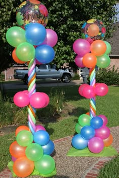 balloons and streamers are on the ground in front of a house