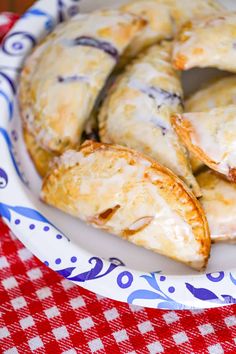 a plate topped with pastries on top of a red and white checkered table cloth