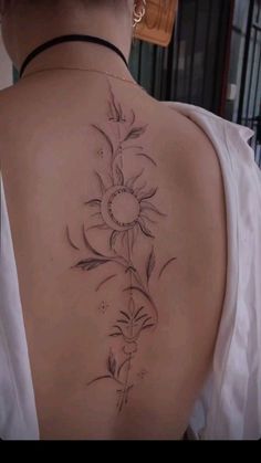 the back of a woman's shoulder with flowers on it