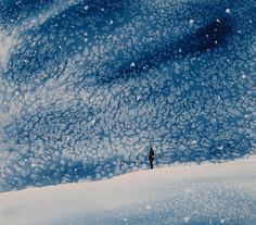 a person standing on top of a snow covered slope under a blue sky with clouds