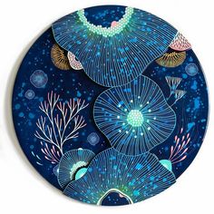 a blue plate with an image of seaweeds and corals painted on it