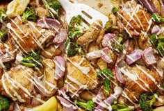 a pan filled with chicken, broccoli and onions covered in white glaze