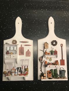 two white cutting boards with various items on top of them and hanging from the wall