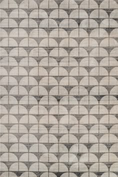 an area rug with circular shapes in grey and white