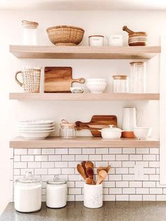 the shelves are filled with dishes and utensils