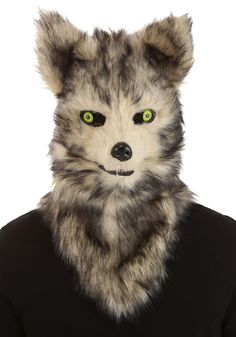 a person wearing a wolf mask with green eyes