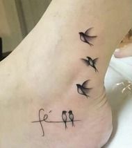 a small bird tattoo on the side of a woman's foot, with three birds flying