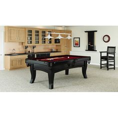 a pool table in the middle of a living room with chairs and cabinets around it