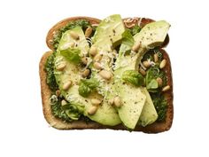 a sandwich with avocado, spinach and chickpeas is shown on a white background