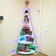 a white christmas tree shelf with pictures on it