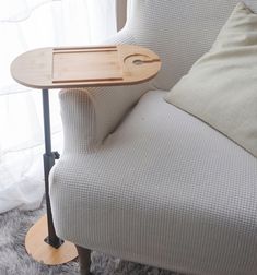 a wooden tray sitting on top of a table next to a chair