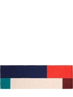 the multicolored rug is on display in front of a white background with an orange, blue, and red stripe