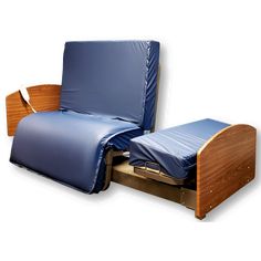 a bed with a blue sheet on top of it and a wooden foot rest in the middle