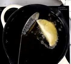 a frying pan with some food inside of it on top of a stovetop