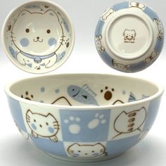 a blue and white bowl with two matching bowls in the shape of cats on it