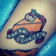 a tattoo on the leg of a person with a ribbon around it that says stay golden