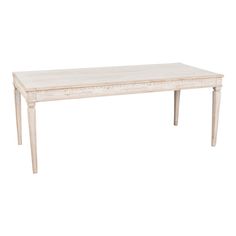 a white wooden table sitting on top of a white floor