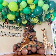 a giraffe sitting on top of a pile of balloons