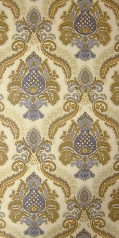 an old fashioned wallpaper with blue and gold designs on it's surface,