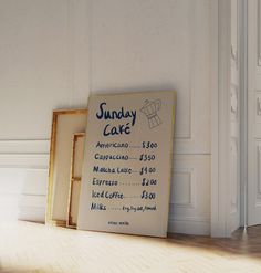 a sign on the floor in front of a wall with an advertisement for sunday cake