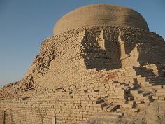 a large brick structure with an elephant head on it's side in the desert