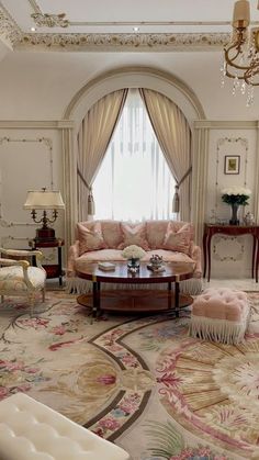 an elegant living room with fancy furniture and chandelier