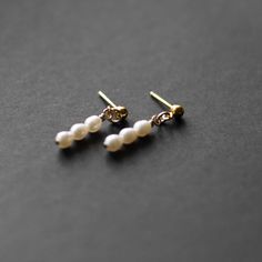 When the occasion calls for a little something extra, our mini Pearl Earrings are the perfect fit. These lightweight earrings are a striking drop style with freshwater pearls.A classic piece of timeless jewelry, these would be the perfect gift for a bride or bridesmaid Details: Size: .75” ling Earring post material: 14k gold fill (100x more real gold than plated materials), perfect for those with sensitivities All profits from the sale of our ethically made jewelery are donated to charity, you c Minimalist Pearl Charm Earrings For Formal Occasions, Minimalist Pearl Drop Earrings For Formal Occasions, Delicate Sterling Silver Pearl Drop Bridal Earrings, Delicate Sterling Silver Bridal Earrings With Pearl Drop, Minimalist Pearl Earrings For Anniversary, Minimalist Pearl White Pearl Earrings For Wedding, Delicate White Gold Pearl Earrings, Minimalist Teardrop Pearl Earrings For Wedding, Delicate Hypoallergenic Pearl Earrings For Formal Occasions