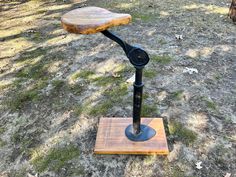 a wooden and metal object sitting in the grass