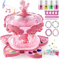 a pink toy carousel with lots of accessories