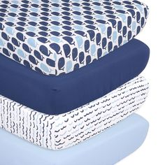 three sheets stacked on top of each other in different colors and patterns, one blue the other white